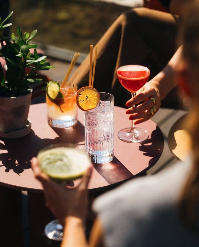 Chilled garnished drinks on a sunlit café table