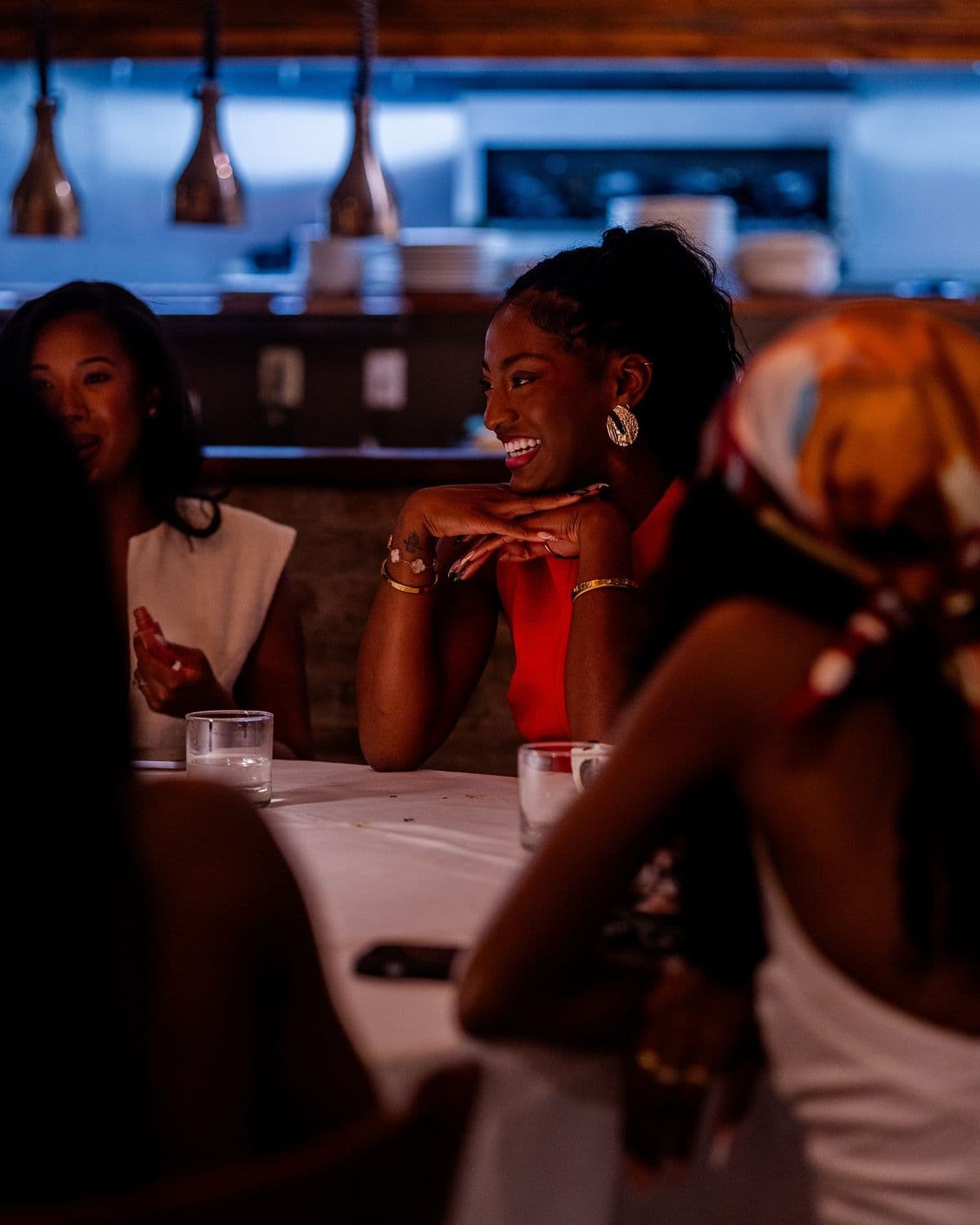 Guests relaxing and talking around a softly lit seating area